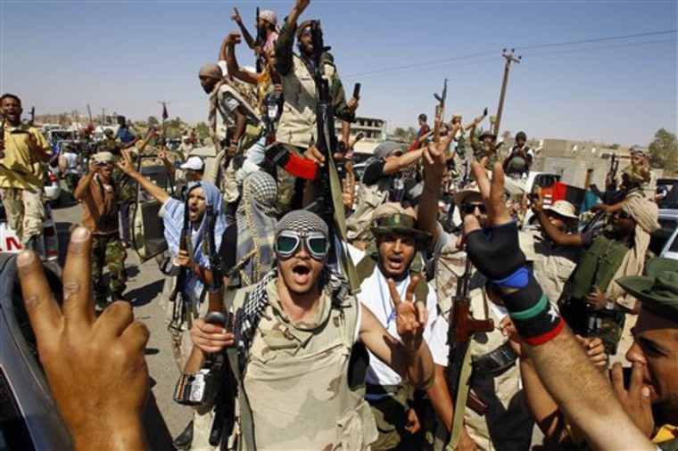Libyan fighters chants slogans as they take control of Moammar Gadhafi loyalists' villages in the desert some 750 km south of Tripoli, at Gohta, north of the southern city of Sahba on Sunday.